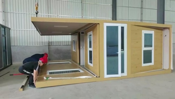 Expandable shipping container house with fold-out design, providing spacious modular living and quick installation for residential or vacation use