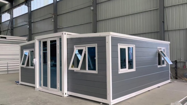 Expandable shipping container house with fold-out design, providing spacious modular living and quick installation for residential or vacation use