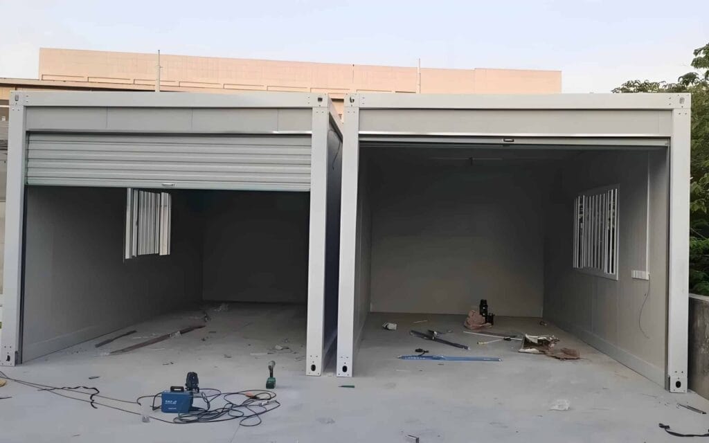 Durable container garage with overhead door, ideal for secure vehicle storage and workshop use