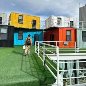 Stylish container hotel made from modular shipping containers, featuring stacked units and modern architecture.