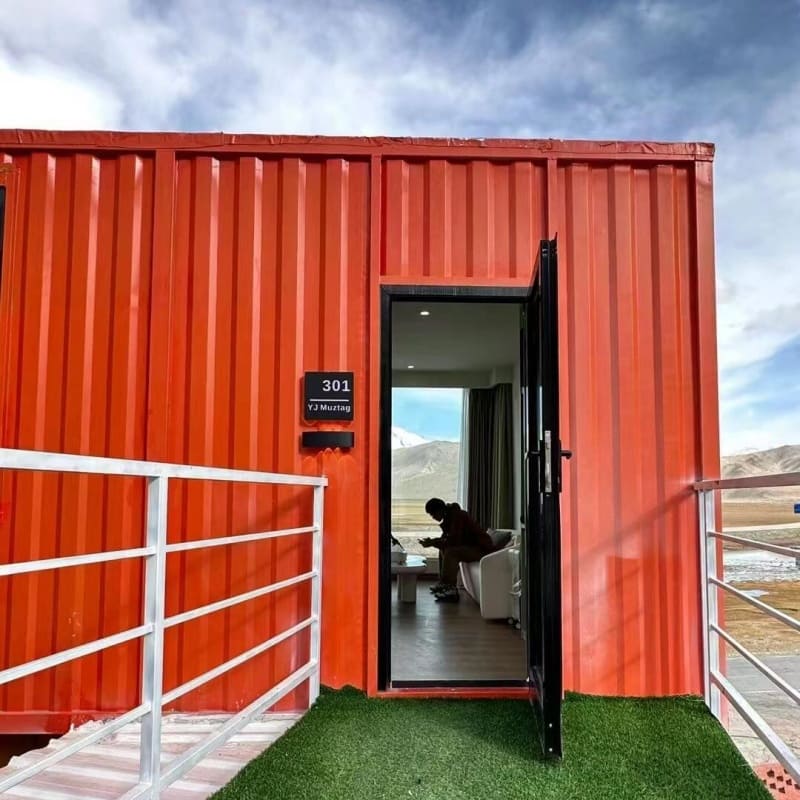 Stylish container hotel made from modular shipping containers, featuring stacked units and modern architecture.