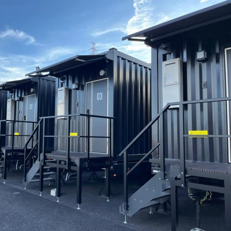 Stylish container hotel made from modular shipping containers, featuring stacked units and modern architecture.